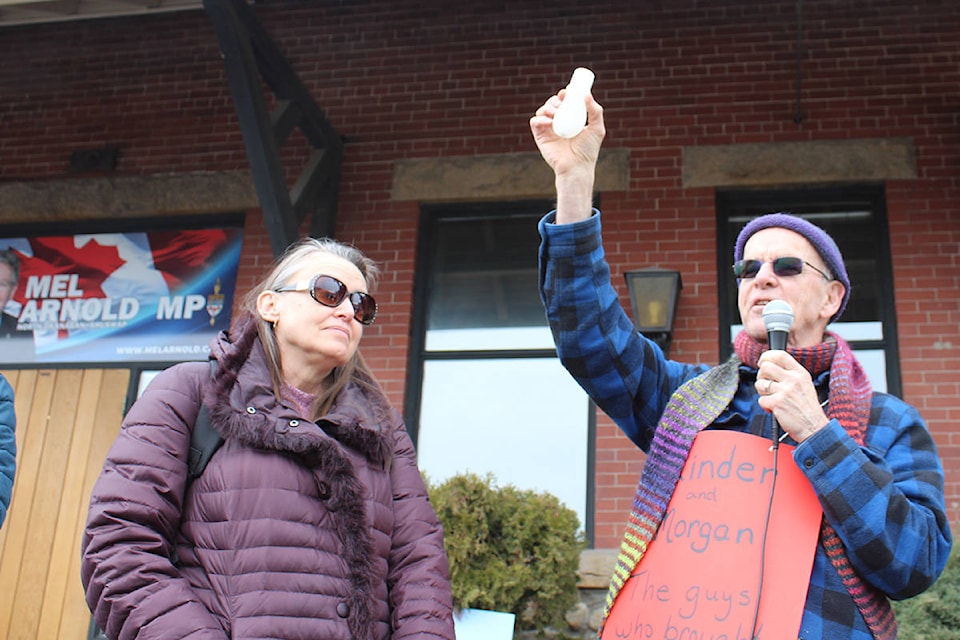 Bill Darnell, right, hoists a vial of water collected from the Salish Sea during a protest held outside North Okanagan—Shuswap MP, Mel Arnold’s Vernon constituency office Friday afternoon as Gail Pifer, one of the event’s co-organizers, looks on. Darnell was one of roughly 50 gathered to demand the federal government take action to stop Kinder Morgan’s proposed Trans Mountain pipeline and tanker project. Though Arnold and his staff were absent during the demonstration, the group left signs and the water sample behind to indicate that they had been on site. (Erin Christie/Morning Star) Bill Darnell, right, hoists a vial of water collected from the Salish Sea during a protest held outside North Okanagan—Shuswap MP, Mel Arnold’s Vernon constituency office Friday afternoon as Gail Pifer, one of the event’s co-organizers, looks on. Darnell was one of roughly 50 gathered to demand the federal government take action to stop Kinder Morgan’s proposed Trans Mountain pipeline and tanker project. Though Arnold and his staff were absent during the demonstration, the group left signs and the water sample behind to indicate that they had been on site. (Erin Christie/Morning Star)