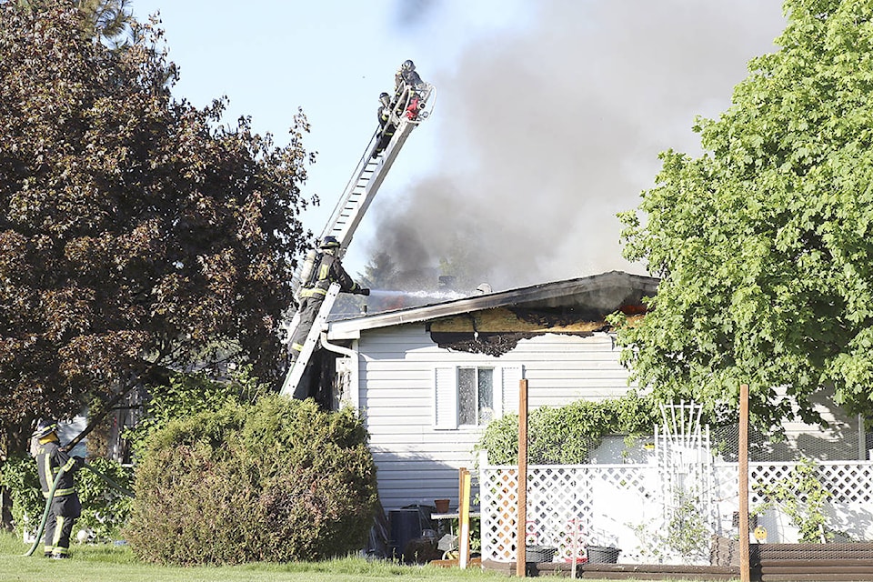 Vernon Fire Rescue crews work to battle a fully-involved blaze that caused significant damage to a Big Chief Mobile Home Park residence Sunday, May 13. (Parker Crook/Morning Star)