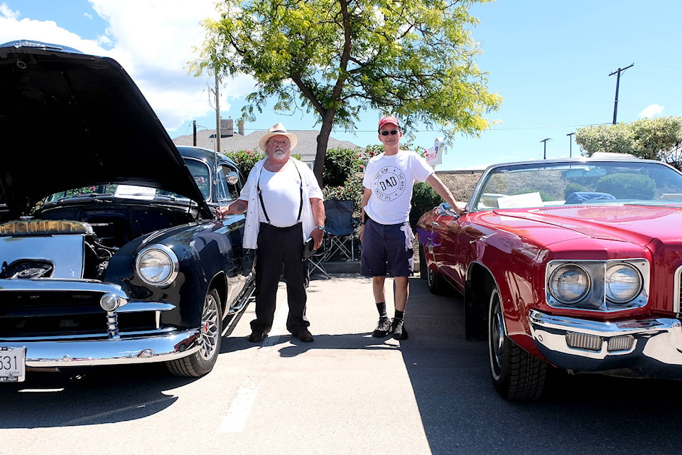 Bill Thorick showcasing his Chevrolet Business Coupe (1950) and Kim Low his Oldsmobile (1971) at the 24th Annual Father’s Day Car Show at the Village Green Mall parking lot. (Tobias Frederiksen/Morning Star)