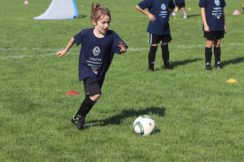 Penticton’s Lagos Kroeker, 8, takes aim at the ball during the Whitecaps FC summer camp on Aug. 14 at Marshall Field. Photo: Brendan Shykora - Morning Star Staff