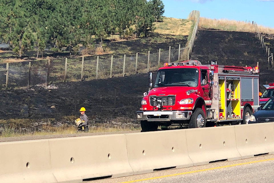 BC Wildfire crews joined Vernon and Coldstream firefighters to extinguish a grass fire on the hillside south of Vernon off Highway 97 Thursday afternoon. (Jennifer Smith - Morning Star)