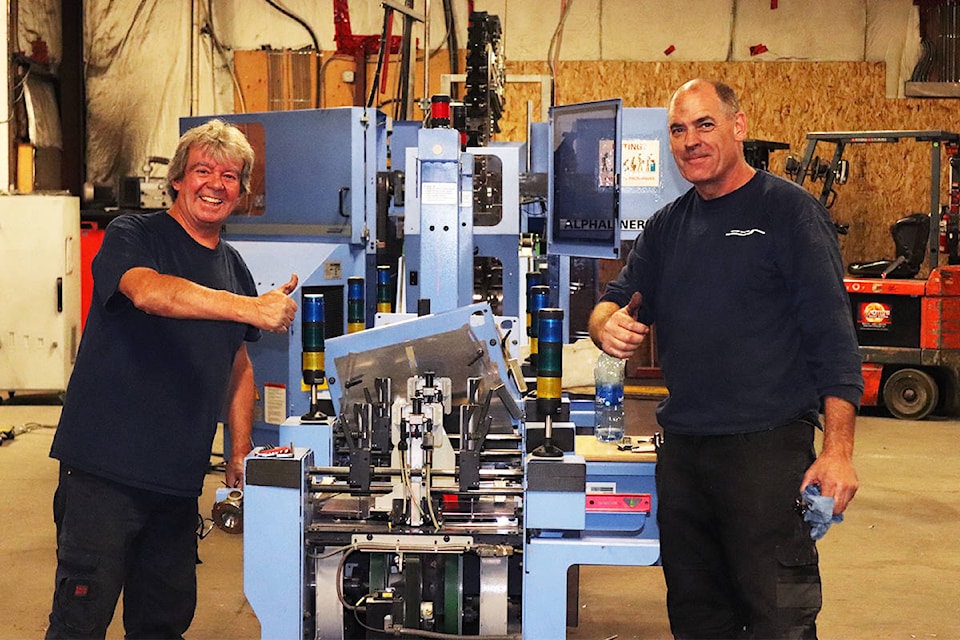 Michel Beaudoin (left) and Dave Nex of Muller Martini Canada were in the Vernon Morning Star production warehouse Saturday. It’s Day Two of installing the new and improved flyer machine at Morning Star headquarters. (Brendan Shykora - Morning Star)