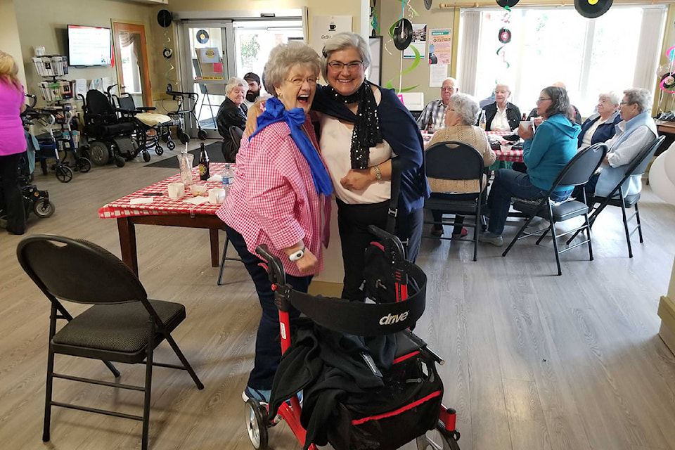 Resident Erna Wiebe (left) shakes a leg with hairdresser Sheila Mandreck during Good Samaritan Canada Heron Grove’s 50s-diner theme party Wednesday to help the Good Samaritan Society celebrate its 70th anniversary. (Roger Knox - Morning Star)