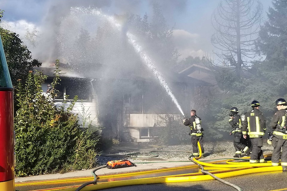 Vernon Fire Rescue Services work at snuffing a house fire on 35th Avenue, across from Silver Star Elementary School, on Thursday, Sept. 25. (Roger Knox - Morning Star)