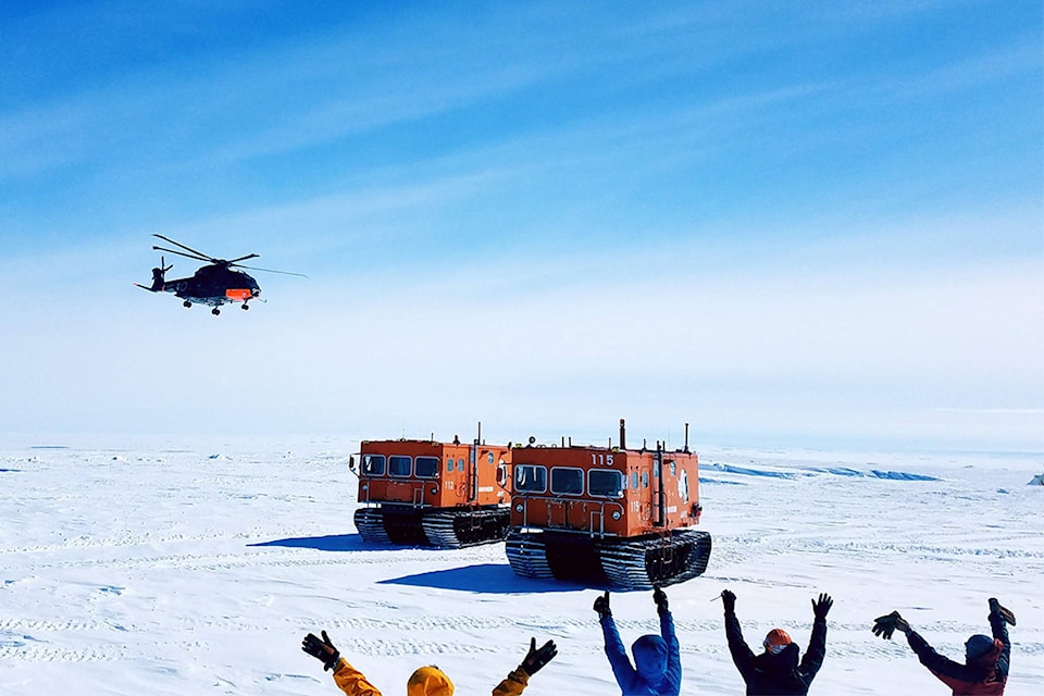 19761205_web1_Researchers-wave-to-an-oncoming-helicopter-at-a-base-in-Antarctic.--Photo--Doug-Sperlich--bigger-photo