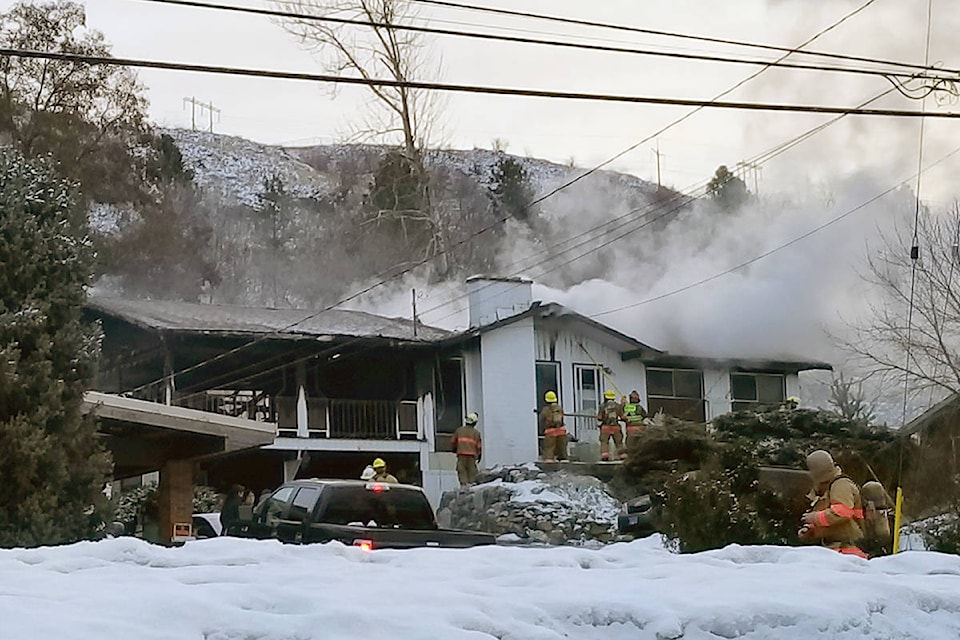 Smoke billows from a home on Kalamalka Road in Coldstream as firefighters work to knock down the blaze Feb. 4. (Roger Knox/Morning Star)
