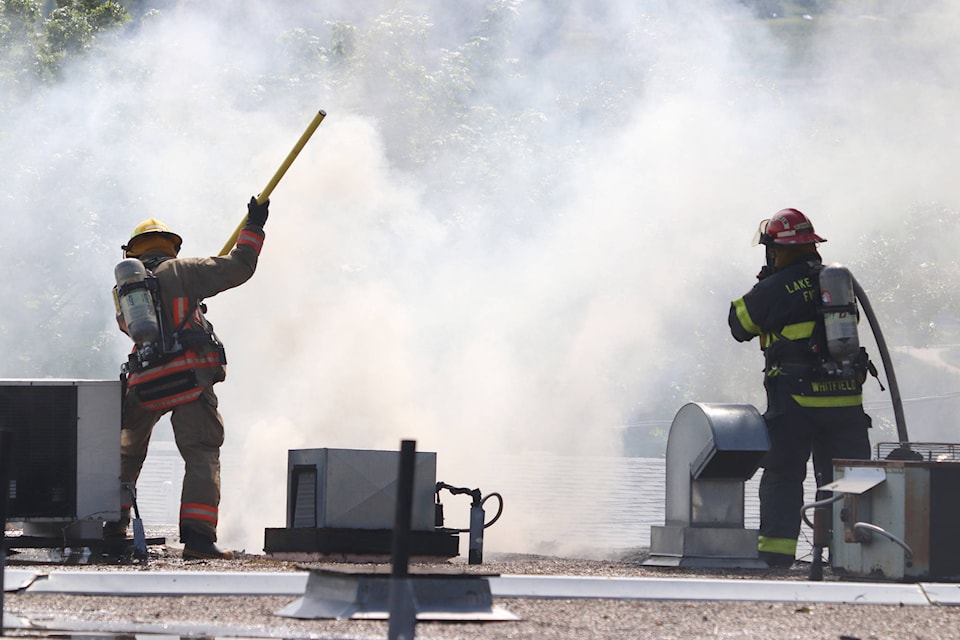 Lake Country firefighters work from the roof to extinguish a fire at the old sausage factory off Pelmewash Parkway Monday, June 1, 2020. (Jennifer Smith - Morning Star)