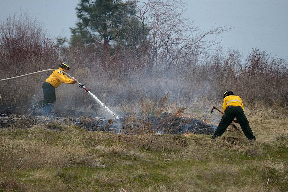 West Kelowna fire crews snuffed out patches of flame that ignited on the side of Highway 97 near the west side of William R. Bennett Bridge Saturday, March 20, 2021. (Phil McLachlan - Capital News)