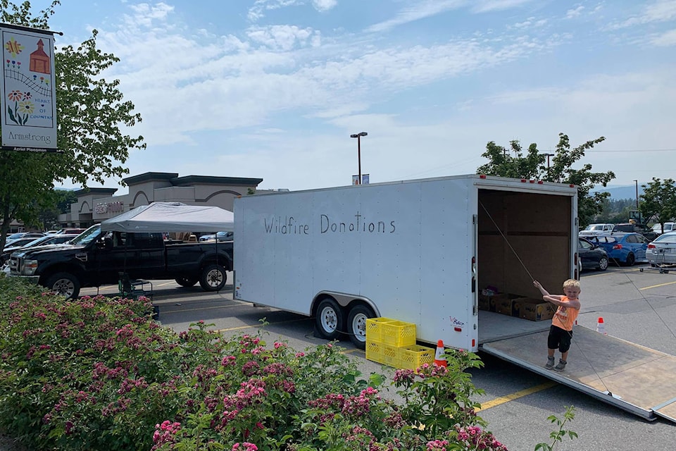 Levi Krause shows off the wildfire donations trailer in Armstrong July 1, 2021. Goods collected are destined to aid the victims of the devastating June 30 fire that destroyed the village. (Matt Jubinville - Contributed)