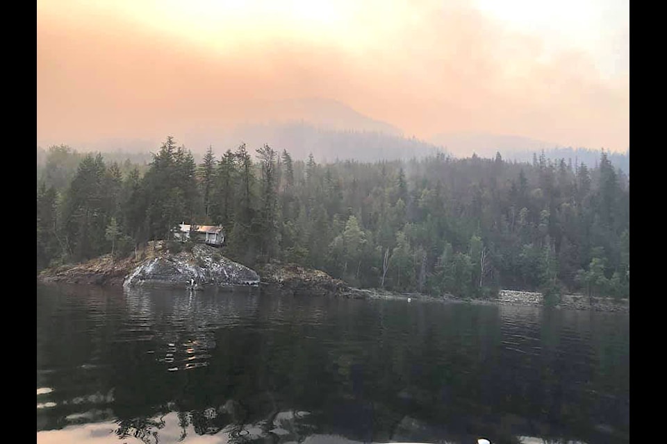 A lone cabin on Mabel Lake stands as the Bunting Road wildfire continues to burn north of Lumby. (Greg Maier photo)