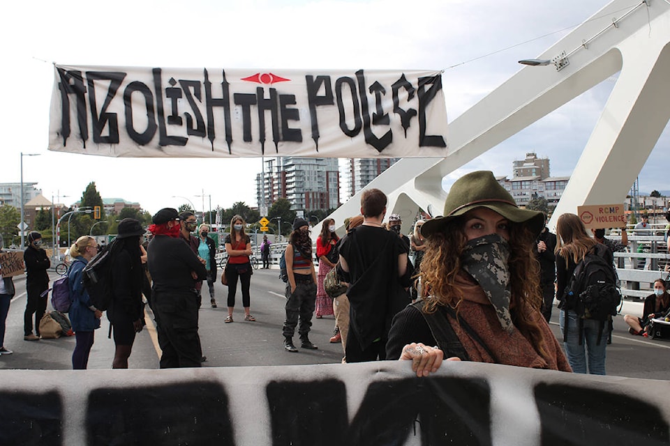 Protesters block the Johnson Street bridge in Victoria ahead of evening commuter time Tuesday. (Jake Romphf/News Staff)