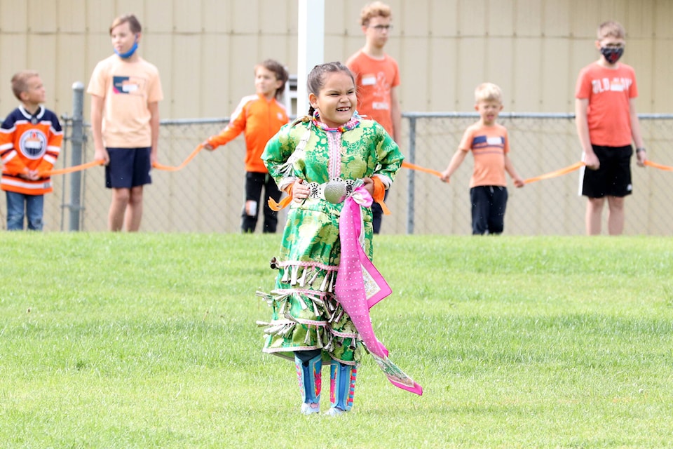 Grade 3 BX Elementary student Jazmin Robins-Swanson performs a jingle healing dance at the school while her classmates form a circle during Orange Shirt Day Sept. 29. (Jennifer Smith - Morning Star)