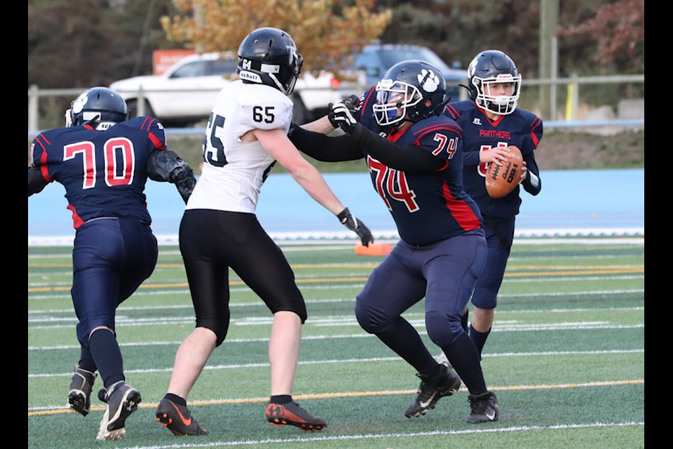 Vernon Panthers offensive lineman James Lehoux (74) takes care of South Kamloops Titans defender Chance Brandon (65) while protecting quarterback Cole Budgen during the Panthers’ 45-8 romp in Okanagan AA/AAA Hybrid Division Junior Varsity Football League play Wednesday, Oct. 27, at Greater Vernon Athletic Park. (Roger Knox - Morning Star)