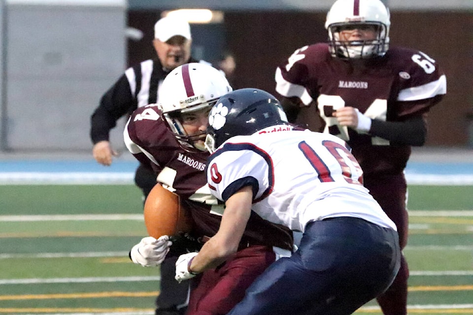 Fulton Maroons ball carrier Reid Williamson gets an up-close-and-personal look at Vernon Panthers tackler Anderson Bicknell during the Battle of Vernon Junior Varsity regular-season finale for both teams Wednesday, Nov. 3, at Greater Vernon Athletic Park. The Panthers downed their crosstown rivals 22-14. (Roger Knox - Morning Star)