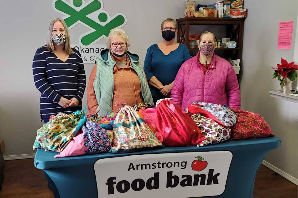 Vienna Demontigny (second from left) donates items for her annual Purse Project to Armstrong Food Bank representatives Jennifer Ciccone (from left), MaryAnn Setterstrom and Karen Harrison. (Roger Knox - Morning Star)