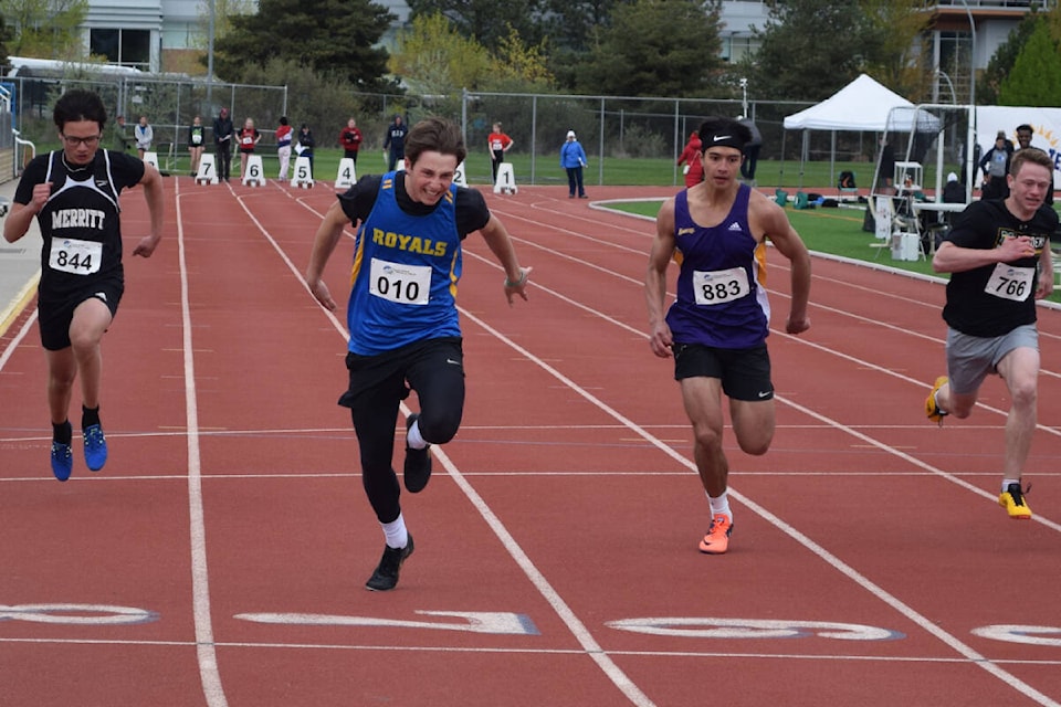Ben Tishenko of the Vernon Christian School Royals (010) breaks the tape in second place in the junior mens 100-metre dash at the Okanagan Valley High School Track and Field Championships Thursday, May 19, in Kamloops. (Chris Bannick photo)