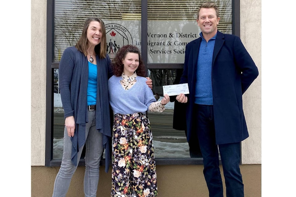 Vernon and District Immigrant and Community Services Society (VDICSS) executive director Amelia Sirianni (centre) receives a donation from the Willis Family Foundation’s Noelle Crombie (left) and Brendan Willis. The money will be used for VDICSS’ post-secondary immigrant bursary program. (Contributed)