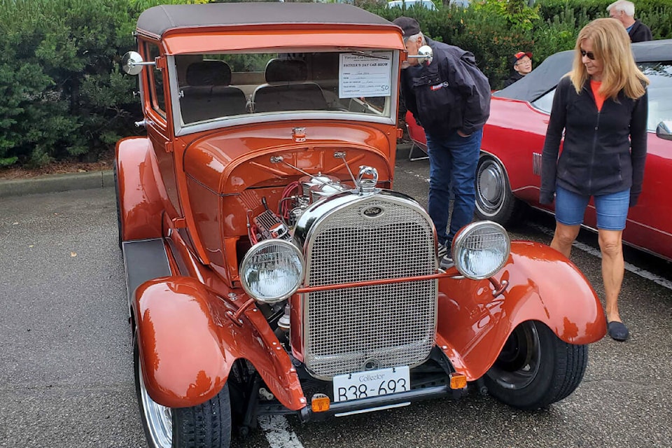 Wayne and Sherree Byer of Merritt take a close look at Vernon’s Bob Karr’s 1928 Ford Sports Coupe at the Vintage Car Club of Canada North Okanagan chapter’s Father’s Day Car Show, Sunday, June 19, at the Village Green Centre. (Roger Knox - Morning Star)