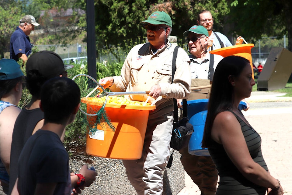 Ron Reitsma of the Kalamalka Fly Fishers Club leads the parade of four bins filled with $1,000 rubber ducks each for the Vernon Lions Club’s Ducks For Dogs Race Saturday, June 25, in Vernon’s Polson Park. (Roger Knox - Morning Star)