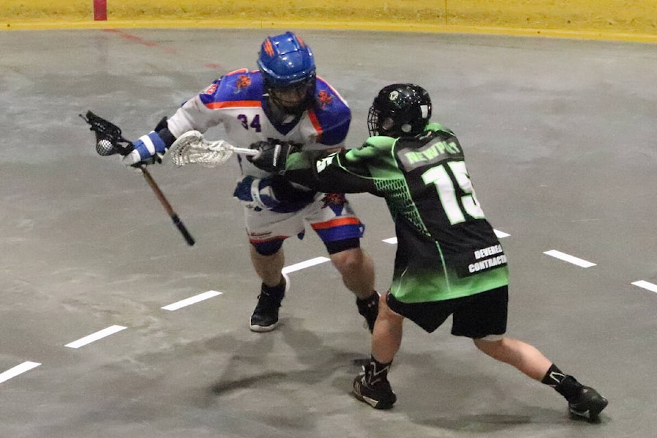 Vernon Iron Ghost Construction Tigers captain Jacob Brewer (left), playing in his final junior game, tries to beat Kamloops defender Elias Newport during the Venom’s 14-3 Thompson Okanagan junor Lacrosse League semifinal win Wednesday, July 13, at Kal Tire Place. The Venom swept the best-of-three series. (Roger Knox - Morning Star)