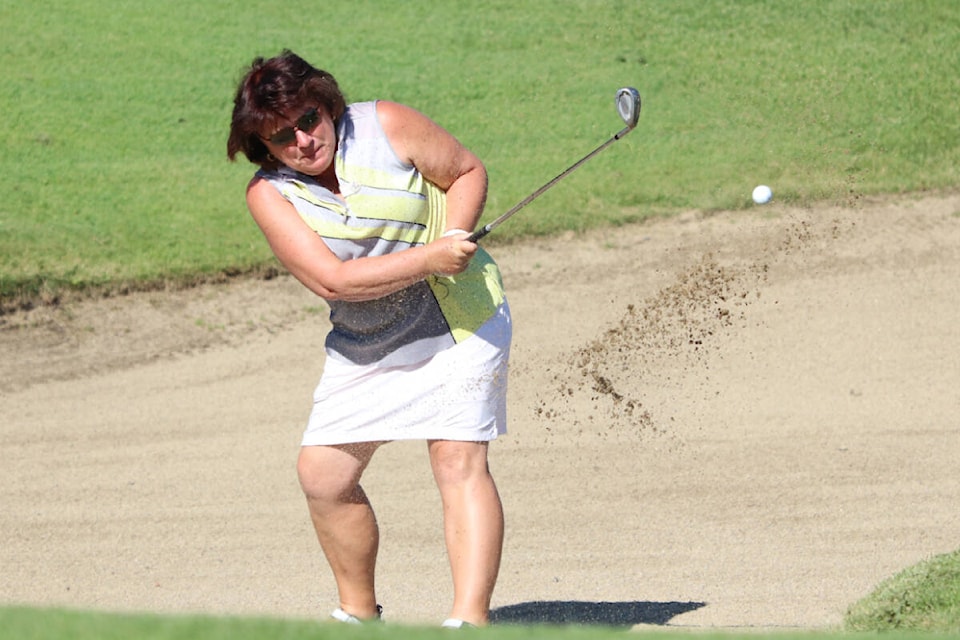 Deb Heale from the host Spallumcheen Golf and Country gets out of sand trouble on the 10th hole during the 2022 Spallumcheen Ladies Open Golf Tournament Wednesday, July 20. (Roger Knox - Morning Star)