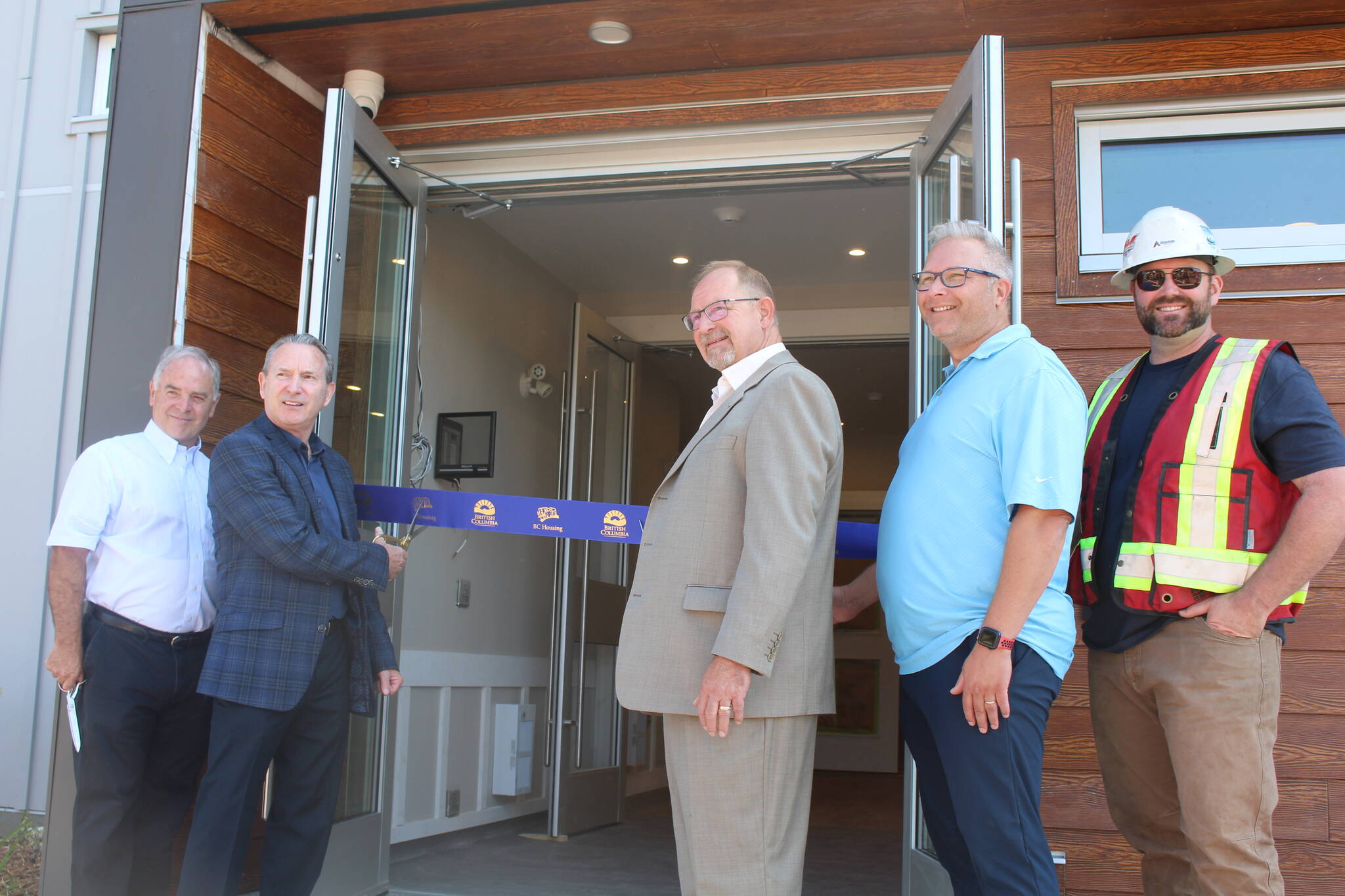 David Raven (Vice-chair, CBT), Randy Driediger (Chairperson, RCHS), Gary Sulz (Revelstoke Mayor), Kelly Miller (BC Housing), and Scott Robertson (Absolute Contracting) cutting the ribbon on July 28. (Josh Piercey/Revelstoke Review)
