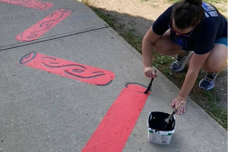 Volunteers gathered at Falkland School Monday, Aug. 29, to help paint an outdoor movement pathway as kids are welcomed back to school on Sept. 7. (School District 83 photo)