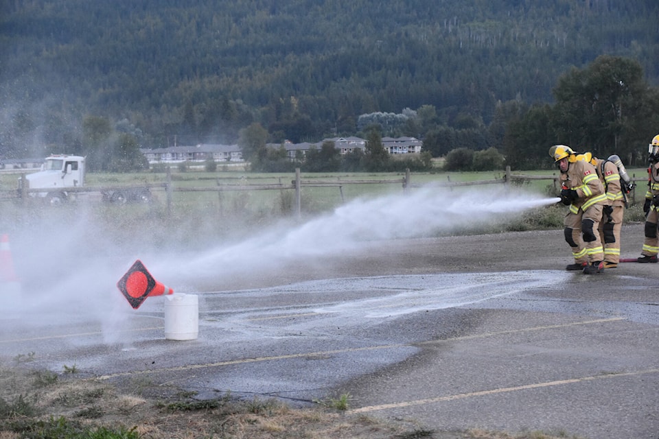 The last segment of the the Combined Timed Activity or CTA on Aug. 30 for the four fire halls which make up the Salmon Arm Fire Department included firing a hose in order to knock a cone off a bucket. (Martha Wickett-Salmon Arm Observer)