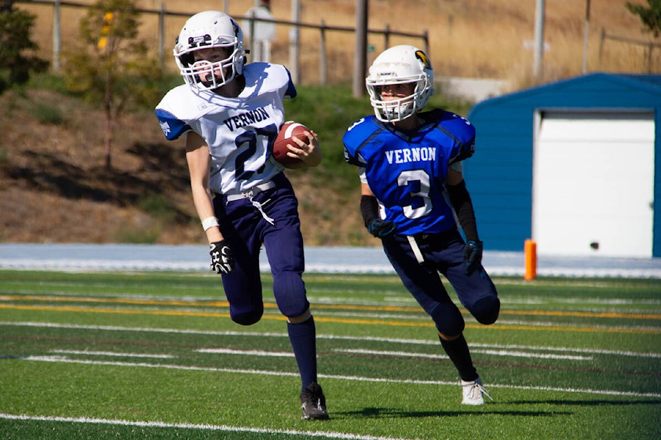 Vernon White Magnums ball carrier Bennett Parsons (27) tries to break away from Vernon Blue Magnums rival Jonah Marion during the all-Vernon Southern Interior Football Conference Pee Wee Division battle Sunday, Sept. 25, at Greater Vernon Athletic Park. (Jenna Fochler Photo)
