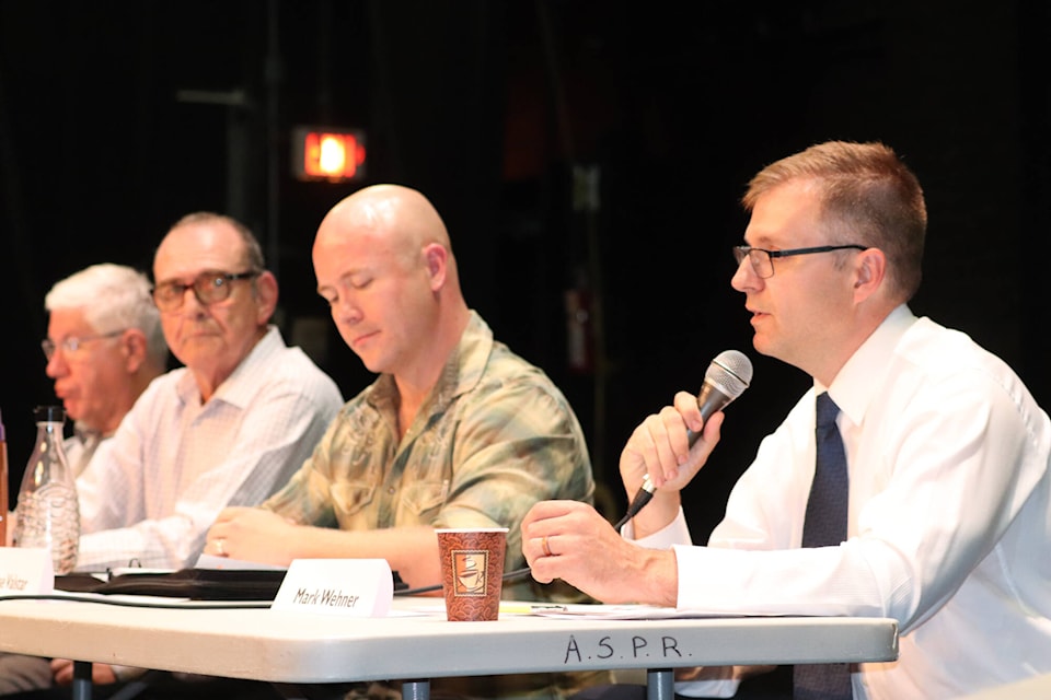 Mark Wehner answers a question at the Armstrong all-candidates forum at Centennial Theatre on Wednesday, Sept. 28, while (from right) Jessie Valstar, Neil Todd and Kim Sinclair get ready for their turns. (Jennifer Smith - Morning Star)