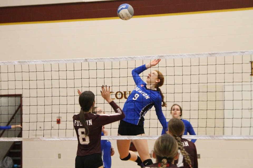 Ava Marginson of the Seaton Sonics (9) goes up to try and spike the ball past Fulton blocker Veronika Ociepa during the Maroons’ senior girls volleyball tournament Friday, Nov. 4, at Fulton Secondary. (Roger Knox - Morning Star)