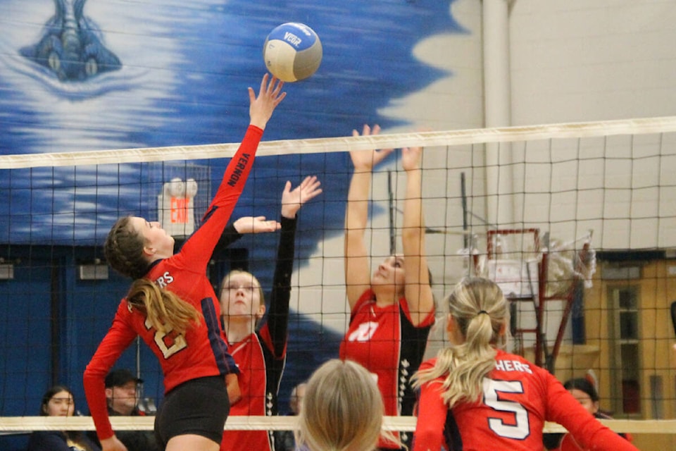 Paige Leahy of the Vernon Panthers (2) tips the ball past the block of Michal Starling (10) of the Revelstoke Avalanche during the North Zone junior girls volleyball championships Thursday, Nov. 10, at Coldstream’s Kalamalka Secondary. (Roger Knox - Morning Star)