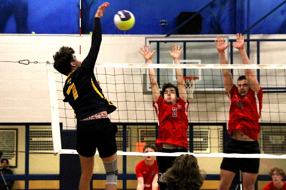 Rory O’Brien of the Kalamalka Lakers (7) blasts the ball past the double block of Aiden Fowler (3) and Nolan Smyth of the Vernon Panthers during the North Zone Senior Boys AA Volleyball championship final Wednesday, Nov. 9, at Kal Secondary. (Roger Knox - Morning Star)