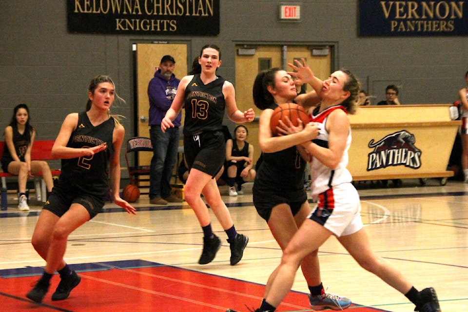 Vernon Panthers guard Dennica Paull (right) meets Destiny, in the form of an accidental forearm from Penticton Lakers player Destiny Hutchings, during the Panthers’ Pit Classic senior girls basketball tournament Friday, Dec. 9, at VSS. (Roger Knox - Morning Star)