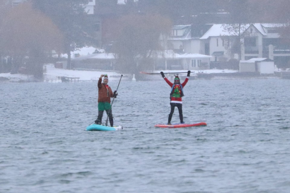A couple of paddlers unafraid of the cold took their boards out onto Kalamalka Lake for Kalavida Surf Shop’s Winter Chill Paddle Saturday, Dec. 17, 2022. (Brendan Shykora - Morning Star)