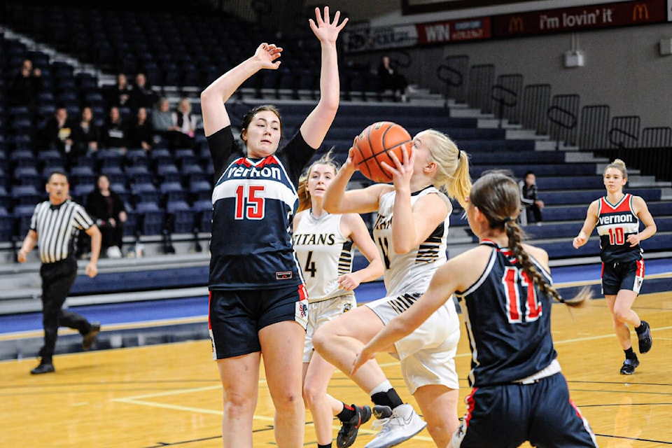 Vernon Panthers forward Maddy Hackman (15) prepares to reject a lay-up attempt from Kiana Kaczur of the South Kamloops Titans during the final of the Tsumura Invitational Rising Stars senior girls basketball tournament Dec. 15-17 in Langley. (Langley Events Centre photo)