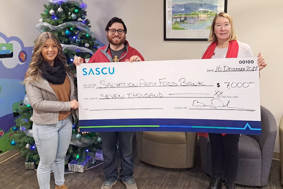 SASCU director June Stewart presents Salmon Arm Salvation Army Food Bank’s Jen Gilfillan Lt. Joel Torrens with a cheque from SASCU for $7,000. (Contributed)