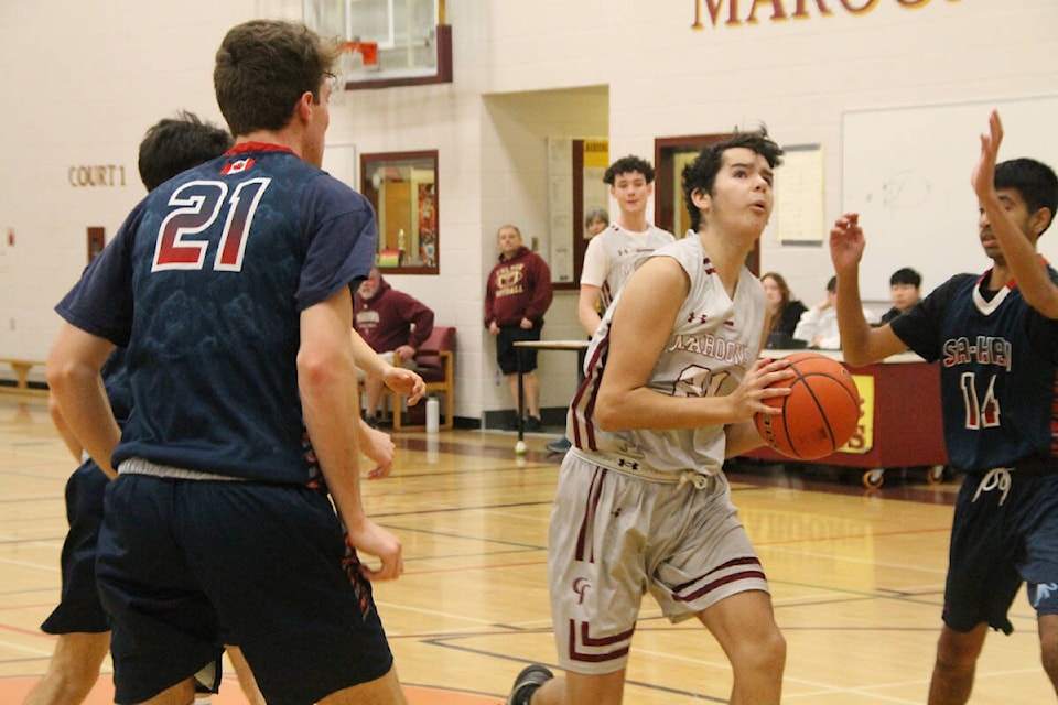 Heatly Jeffers of the Fulton Maroons (with ball) slices between Sa-Hali Sabres (Kamloops) defenders Joey Galloway (21) and Zoraver Ollek (14) during the Maroons’ Corporate Classic Senior Boys basketball tournament Thursday, Jan. 12. (Roger Knox - Morning Star)