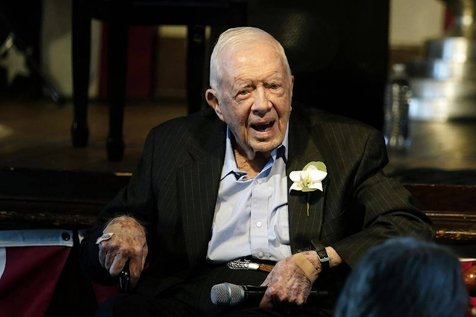 FILE - Former President Jimmy Carter reacts as his wife Rosalynn Carter speaks during a reception to celebrate their 75th wedding anniversary, July 10, 2021, in Plains, Ga. The Carter Center said Saturday, Feb. 18, 2023, that former President Jimmy Carter has entered home hospice care. The charity created by the 98-year-old former president said on Twitter that after a series of short hospital stays, Carter “decided to spend his remaining time at home with his family and receive hospice care instead of additional medical intervention.” (AP Photo/John Bazemore, Pool, File)
