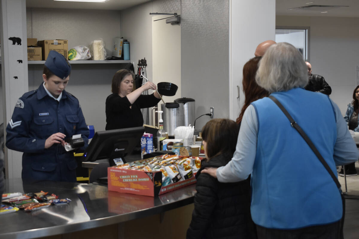 Christina Teshier serving her first customers at the Hungry Bear Power Bites Café on Saturday, April 1. (Logan Lockhart- Western News)