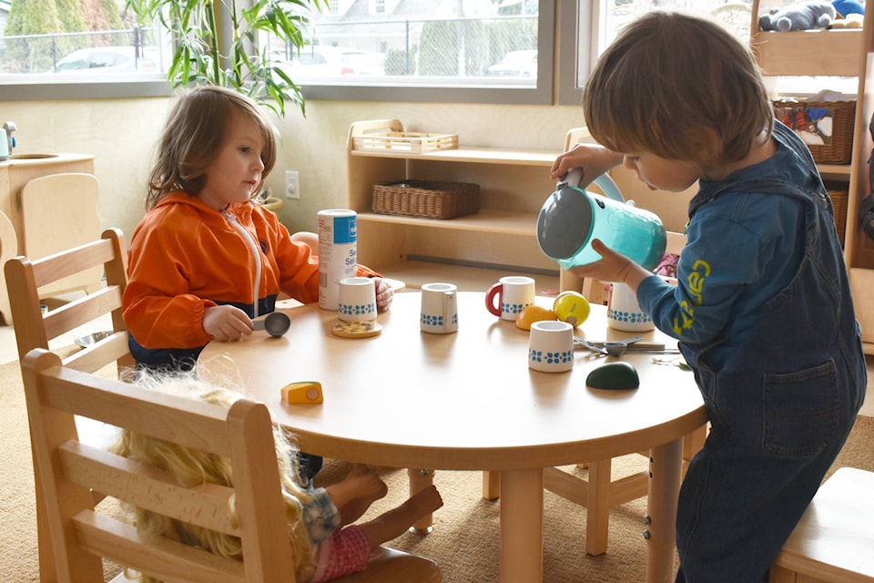 Westyn Hoffman-Gagne and Tristan Perry share in a tea party at the Kids Kingdom Childcare Society open house Saturday, April 1, 2023. (Rebecca Willson/ Eagle Valley News)