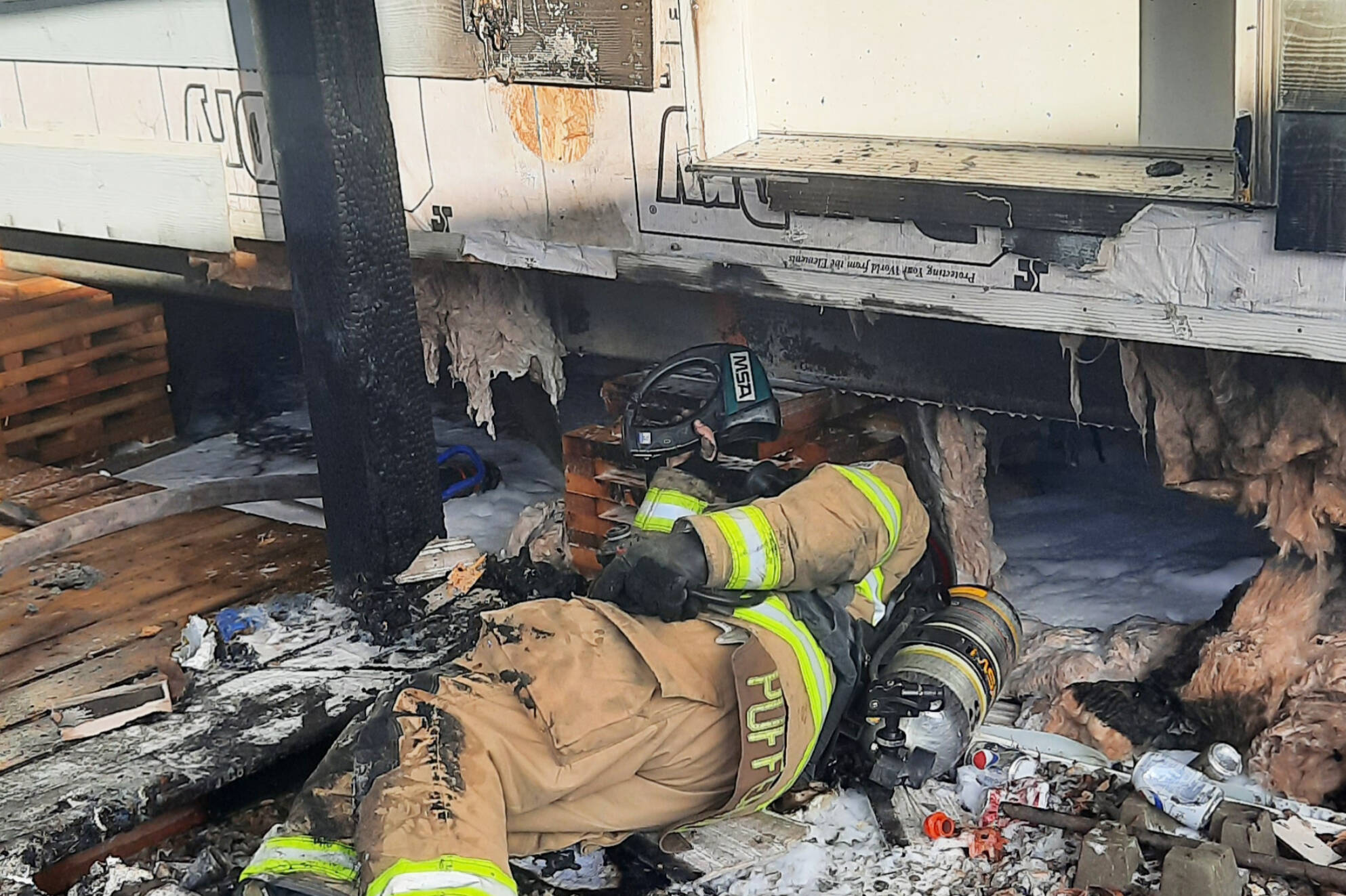 32362729_web1_230412-SAA-trailer-firefighter-underneath