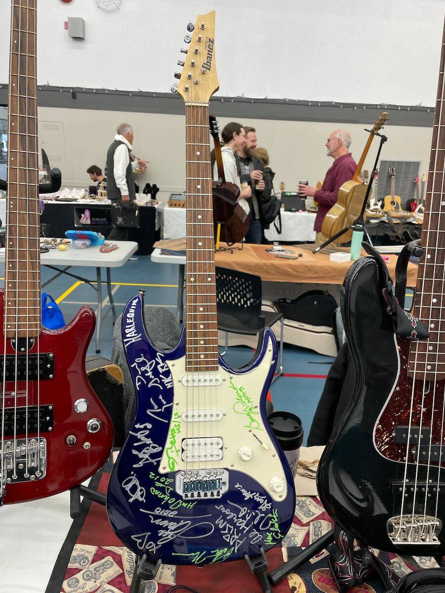 Guitar collector Neil Merchant is hoping to sell this guitar signed by Canadian bands members of Prism, Harlequin, The Headpins and Honeymoon Suite on Saturday at the six annual Okanagan Guitar Show. (Gary Barnes/Capital News)
