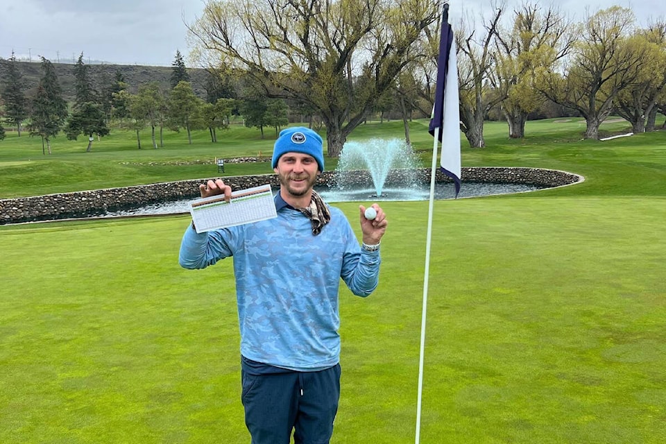 Vernon Golf and Country Club pro/grounds crew member Bryce Barker holds up his scorecard and his ball after putting out on No. 18 with an (unofficial) course record score of 14-under-par 58. (Contributed)