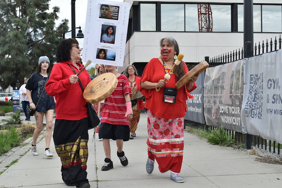 Hundreds of people marched the streets of downtown Kelowna for Red Dress Day on Friday, May 5. (Jordy Cunningham/Capital News)