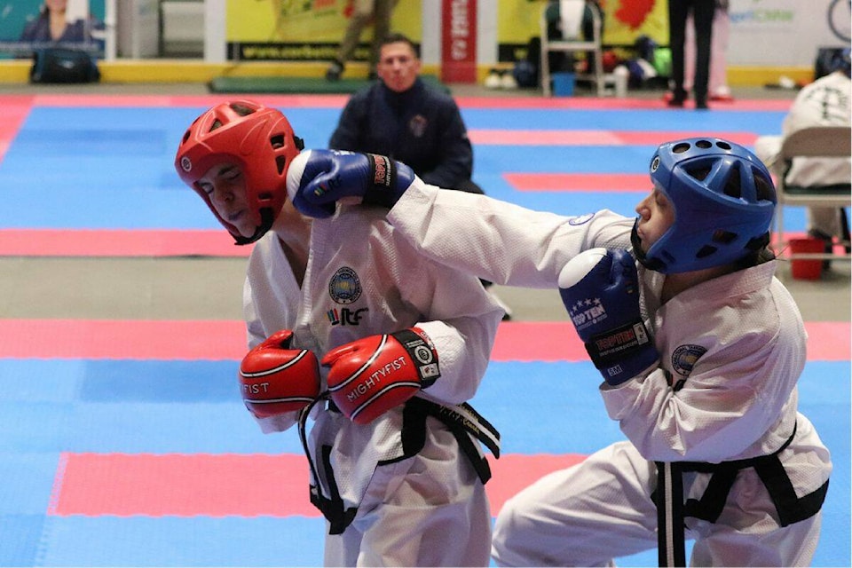 Alexandra Thompson from Northern Taekwondo Academy in Sun Peaks (red) battles with Erica Jacobson from North Wake Martial Arts out of Prince Albert, Sask., on Sunday, May 7, action from Vernon’s Kal Tire Place. (Bowen Assman/Morning Star)