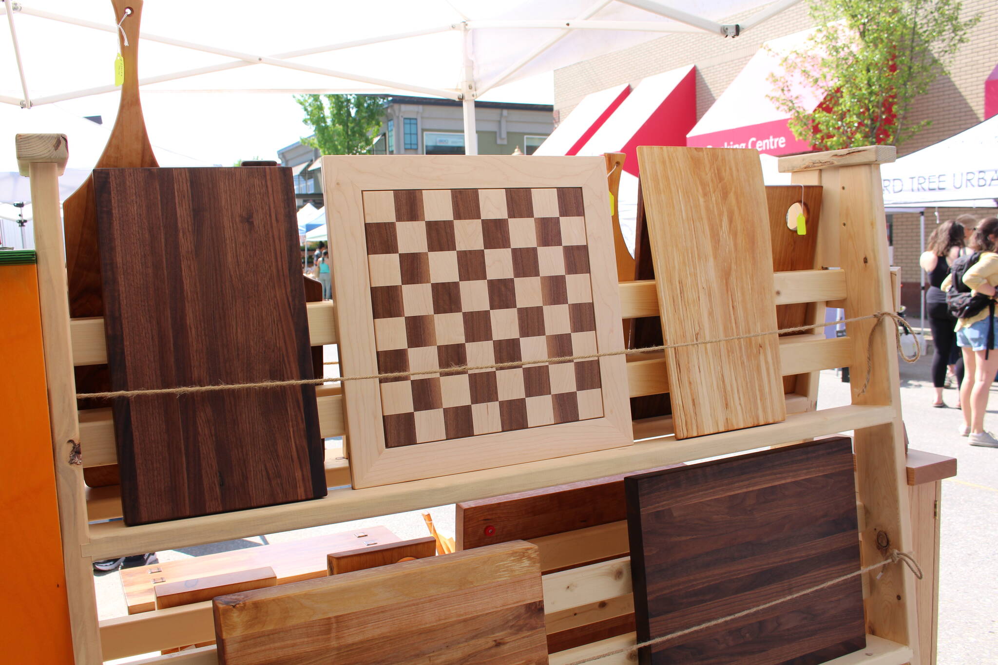An array of cutting boards and a chess board at Schills Woodworking Shop stand. (Zachary Delaney/Revelstoke Review)