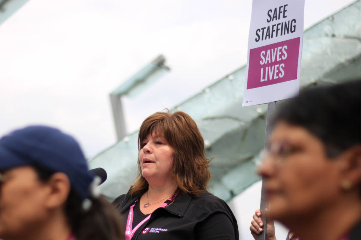 B.C. Nurses Union vice-president Adriane Gear speaks at a protest Wednesday (May 31, 2023) that saw hundreds of nurses in town for a BCNU conference march along the streets of Vancouver calling for safer staffing levels. (Lauren Collins)