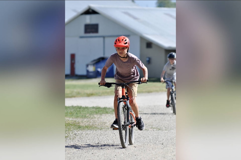 Logan Falt races in the bike portion of the 28th annual Highland Park Elementary Iron Kids Triathlon Friday, June 2, at the IPE Grounds in Armstrong. The event is for the school’s Grade 4 and 5 students and starts at the local outdoor pool, followed by cycling at the IPE grounds and finally a running circuit around the school grounds. (Graeme Corbett Photo)