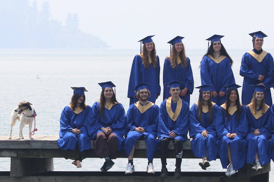 Kal Secondary students pose for their photo, while a furry friend looks on. (Bowen Assman Photo)